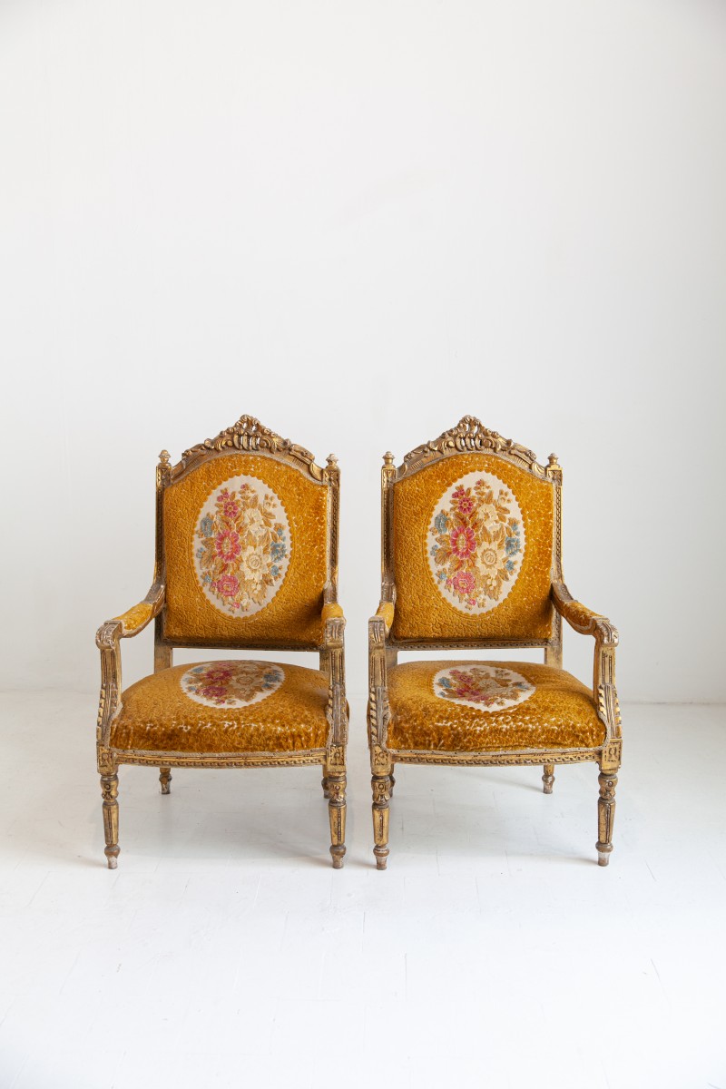 Pair of golden armchairs in Louis XVI style.