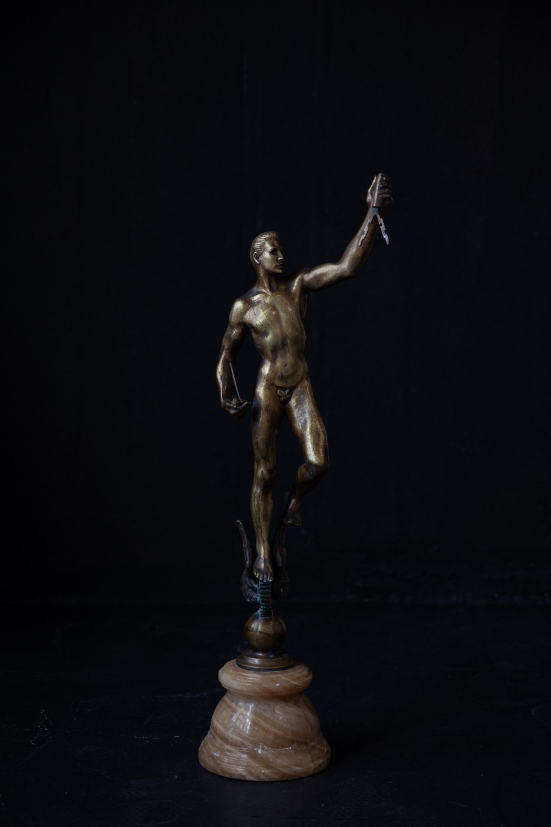 Industrial bronze figure on pink marble base